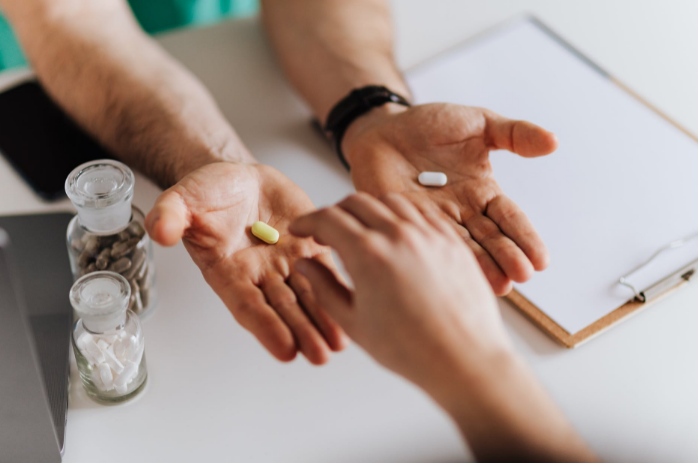 hand holding supplement pills